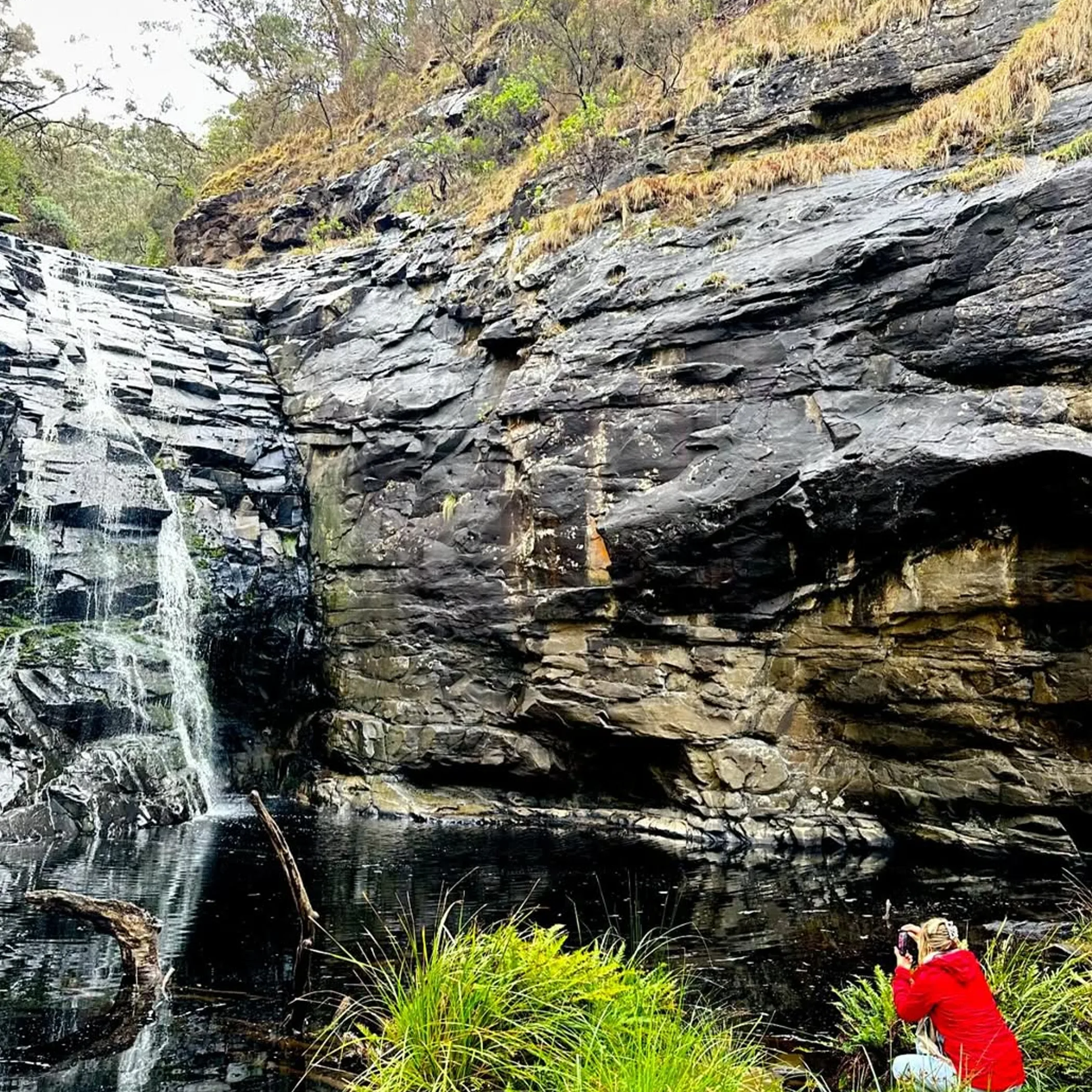 waterfall, rocky gorge, and hiker